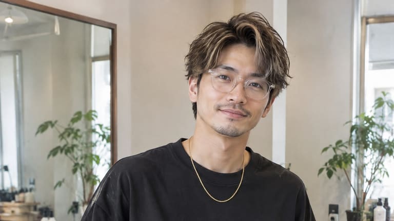 黒いシャツを着て仕事場に立つ人